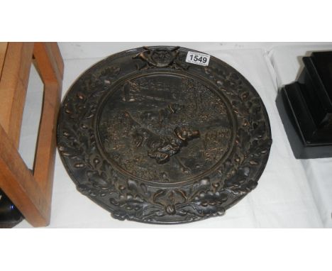 A late 19th / early 20th century pewter wall plaque depicting hunting dogs.