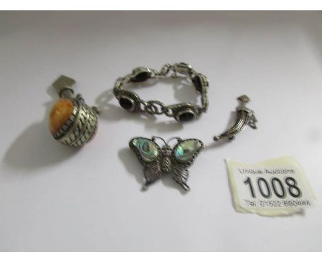 A silver bracelet, a white metal dagger brooch, a white metal dagger brooch and a white metal scent bottle.
