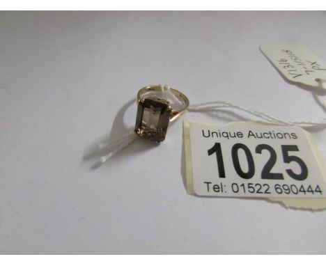 A smokey quartz set ring in 9ct gold with openwork mount, size K.