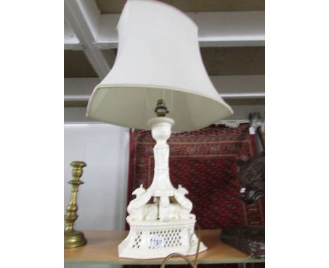 A ceramic table lamp with Griffin's on base and complete with shade.