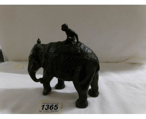 A spelter elephant trinket box with monkey on its back.
