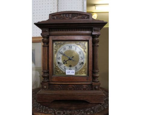 A wood cased mantle clock