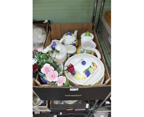 A large selection of Fruit decorated pottery Rayware, together with a similar jug containing ceramic roses
