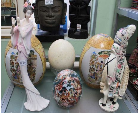 A blown Ostrich egg, together with three ceramic eggs, and a male &amp; female figure (6)