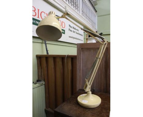 A cream angle-poise lamp
