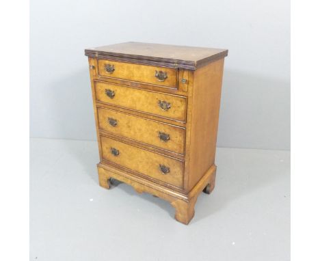 A walnut Bachelor's chest of four drawers, with fold-over top and bracket feet. 60x80x36cm.Top opens to 70cm. This piece prob
