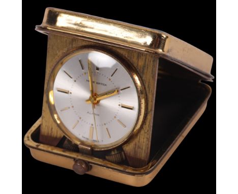 SWISS HOME WATCHES - a Swiss gilt-metal cased travelling alarm clock in folding case, working order, 5cm 