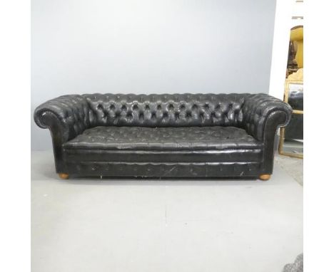 An vintage black leather Chesterfield style sofa. Overall 230x75x95cm, seat 163x42x60cm.Some crackling to leather, particular