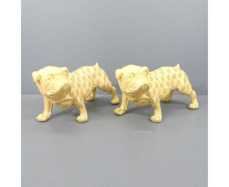 A pair of large ceramic bull dogs, decorated with the Gucci logo. 73x40x33cm.One has crack to front paw. No maker's labels. 