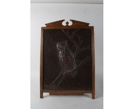 Arts and Crafts copper panel, repousse chased with an owl, housed within an oak frame, 46cm wide x 67cm high