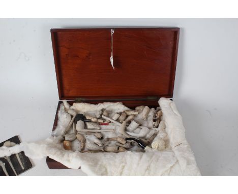 Collection of clay pipes and pipe bowls, to include example in the form of a mile marker, small book on clay tobacco pipes by