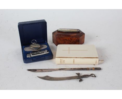 Mixed works of art, to include an ivorine common prayer book, a small burr wood box, 19th century silver bladed and mother of