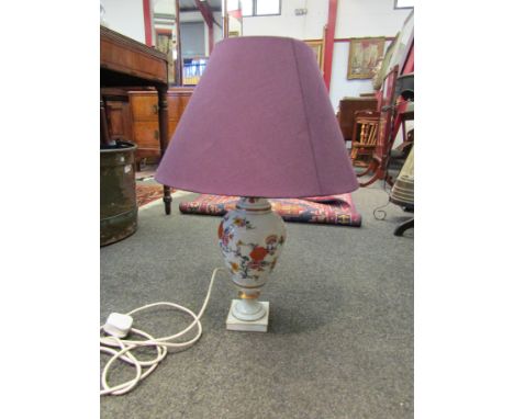 A Limoges ceramic table lamp with floral sprays, purple shade