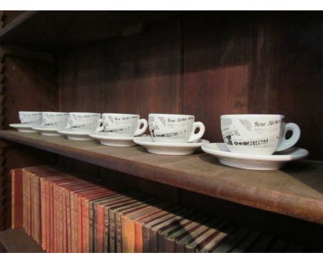 A set of six Italian Nuova Point espresso coffee cups and saucers with news print decoration 