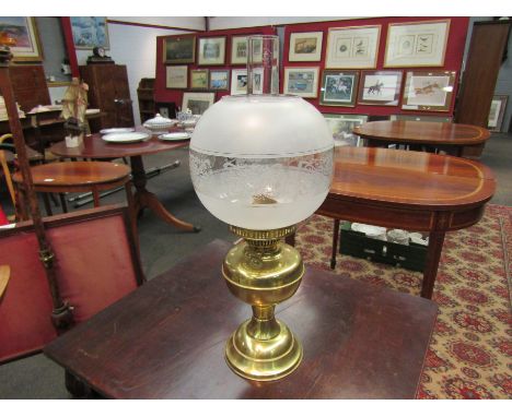 A brass oil lamp with frosted and etched shade          