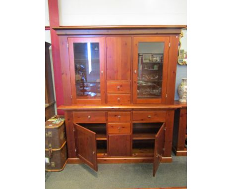 A modern stained pine cabinet with internal lighting and two glazed upper cupboards, 196cm x 176cm x 47cm