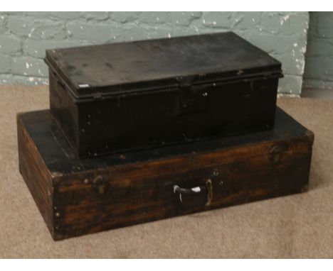 A wooden tool chest along with a tin trunk.