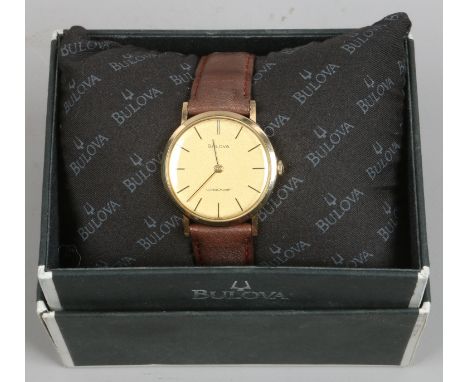 A boxed gents Bulova Longchamp 9ct gold cased manual wristwatch on brown leather strap.