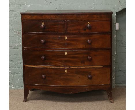 A Georgian mahogany bow front chest of two over three graduated drawers raised on bracket feet, in need of restoration.