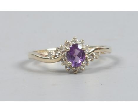 A 9ct gold amethyst and diamond crossover ring, size L1/2.