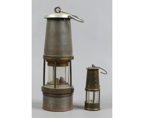 A Wolf No.7 miners lamp along with a similar smaller example.