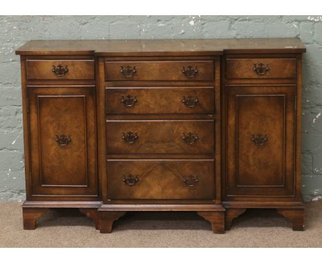 A burr walnut breakfast side cabinet of small proportions, banded in mahogany and raised on bracket feet.