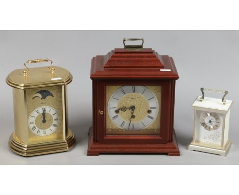 A Franz Hermle three train bracket clock, a Hermle quartz clock with moon roller and a quartz carriage clock.