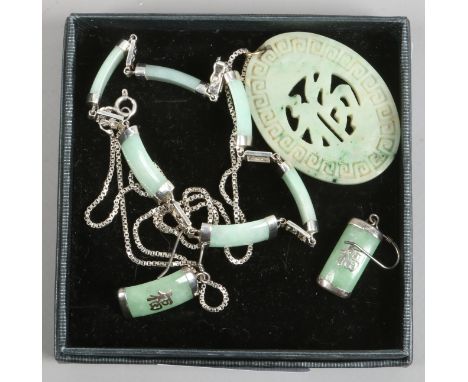 A Chinese pierced jade pendant on silver chain and a silver mounted jade bracelet with earrings en suite.