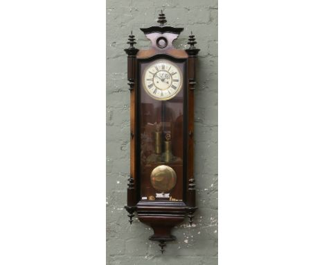 A C19th walnut cased Vienna wall clock with ebonized mouldings. Housing a two train eight day movement striking on a gong.