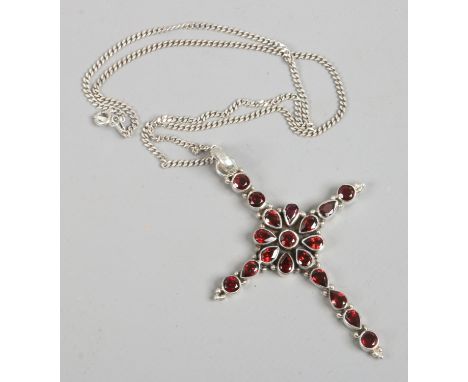 A silver cross pendant set with garnets on a silver chain.