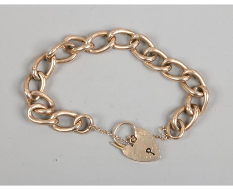 A 9ct gold curb chain bracelet with heart shaped clasp, 14.4 grams.
