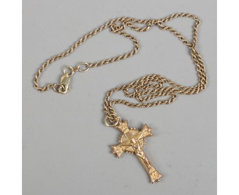 A 9ct gold crucifix pendant on 9ct gold ropetwist chain, gross 3.8 grams.
