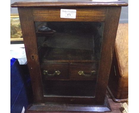 Early 20th Century table top wooden smokers cabinet with glazed front. (B.P. 21% + VAT) Heavy wear with scratches in places. 