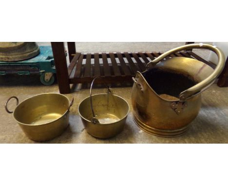 Brass helmet shaped coal scuttle and two brass preserving pans.  (3)  (B.P. 21% + VAT) 