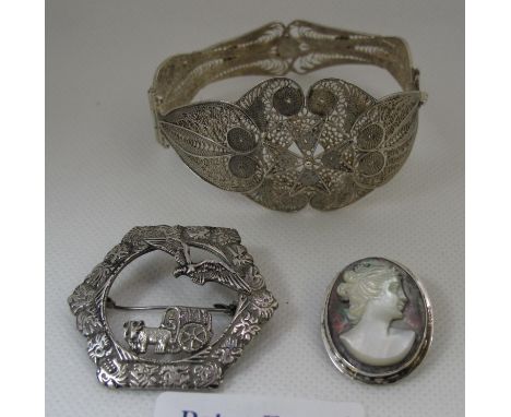 An 800 silver brooch, silver filigree bangle and a mother of pearl cameo brooch.  (B.P. 21% + VAT) 