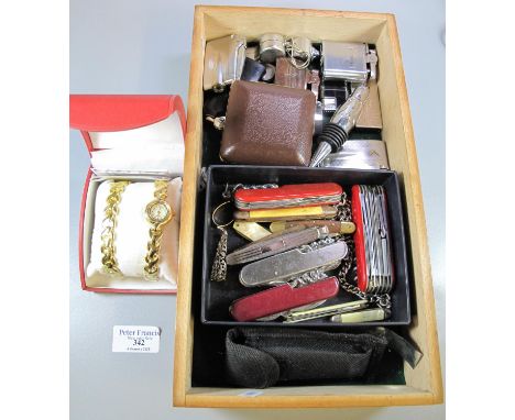 Tray of assorted cigarette lighters, whistles, penknives, alarm clock etc. including many bladed original Swiss Army Knife an