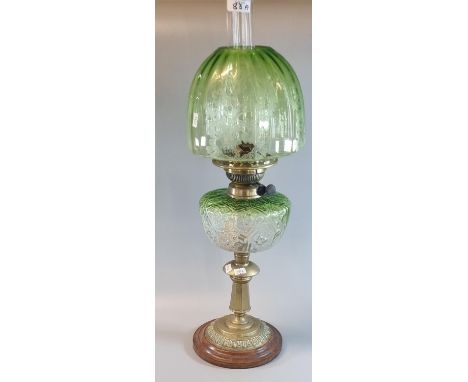 Early 20th Century double oil burner lamp, having green glass etched foliate shade above a green glass moulded flowerhead dec