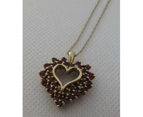9ct gold ruby set heart pendant on fine link 9ct gold chain.  Approx weight 4.1 grams.(B.P. 21% + VAT) 