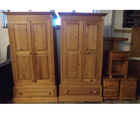 Pair of natural pine two door blind panelled wardrobes, both with under drawers on platform bases.  102cm wide approx.  Toget