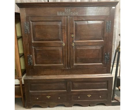 18th century oak two stage vestment cupboard, the moulded cornice above two blind panelled and fielded doors, the interior re