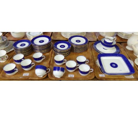 Three trays of Wedgwood blue and gilt dinner and teaware items, to include: various plates, saucers, teacups, milk jug, sugar