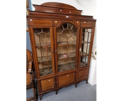 Edwardian mahogany inlaid three door glazed display cabinet standing on tapering legs and spade feet.  (B.P. 21% + VAT) 