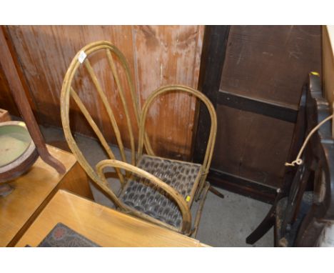 An unusual stick back chair with shell inlaid seat