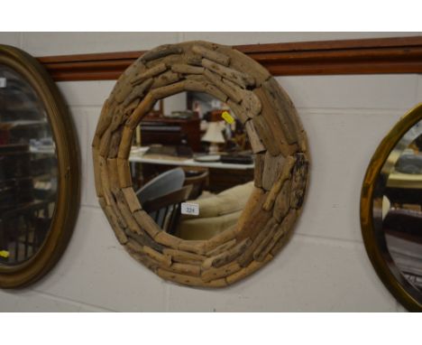 A circular drift wood framed wall mirror 