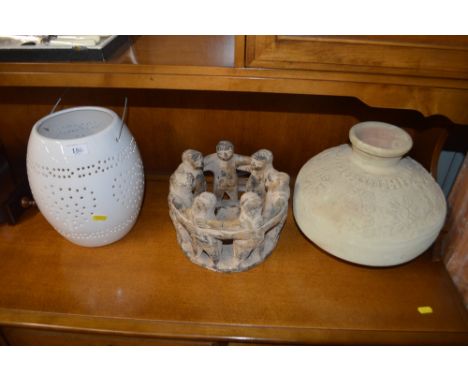 A large ceramic pot; one other pot and a lantern 