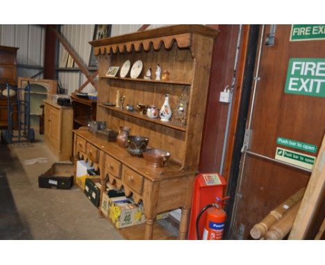 A stripped pine dresser fitted four drawers and pot shelf 