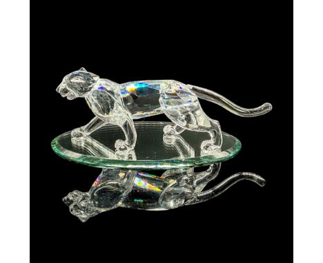 Clear faceted crystal figure of a leopard mid-stride with amber colored eyes. Retired. Swarovski mark. Item number 7610NR0000
