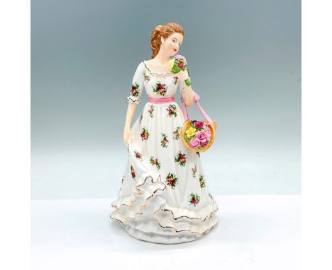 A glossy figure of a woman in a white gown in a Country Rose Pattern, with a pink sash belt. Royal Albert backstamp. Issued: 