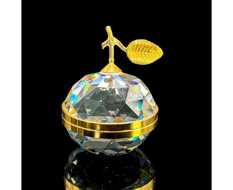 Dazzling cut crystal figure of an apple that opens in the middle to reveal two mirrored surfaces. Gold trim, stem, leaf and h