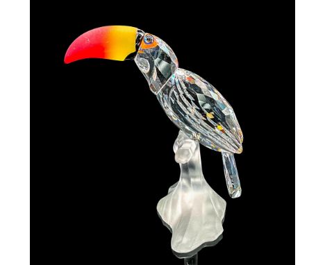 Clear faceted crystal figure of a toucan perched on a satin crystal base. The beak is bright red/orange/yellow in satin cryst